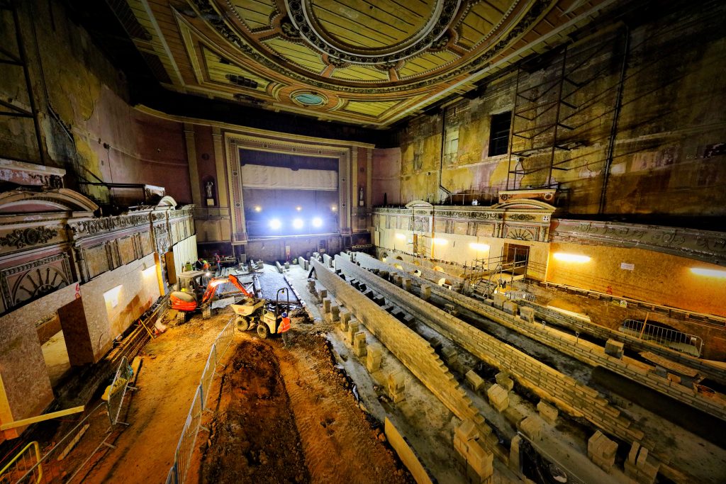 Wide view of the Alexandra Palace theatre floor undergoing restoration and building work