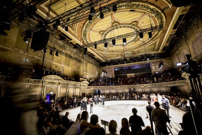 People stood in a circle in the auditorium at Alexandra Palace.