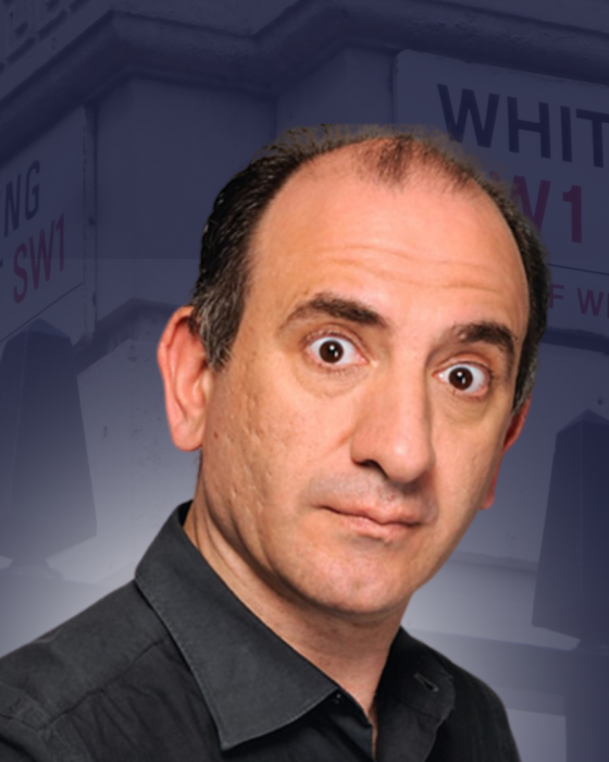 A person with a surprised expression in front of blurred street signs for Downing Street and Whitehall. The tone is comedic and inquisitive.